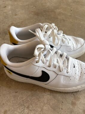 Nike Kids White Sneakers with Black Swoosh and Yellow Heel Tab